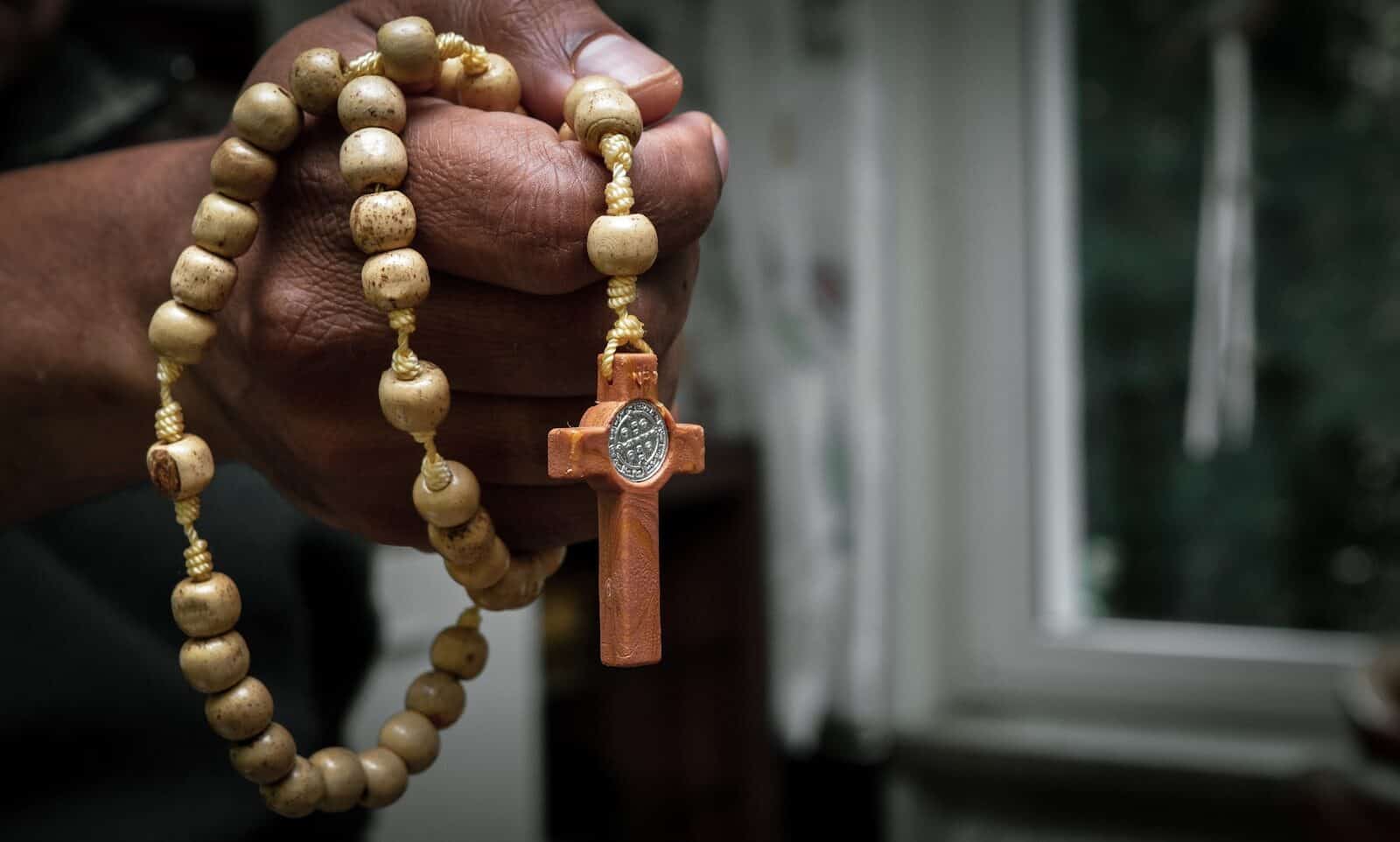 Photo by Anuja Tilj brown beaded necklace on persons hand